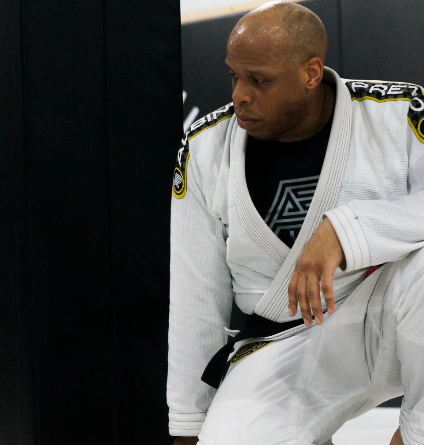 Brazilian Jiu Jitsu black belt instructor standing in the academy
